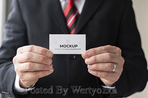 Businessman holding business card mock-up with both hands