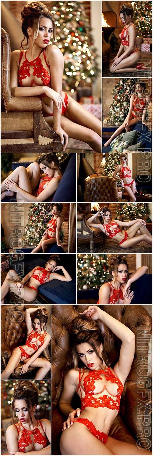Girl in red lingerie on the background of a christmas tree stock photo